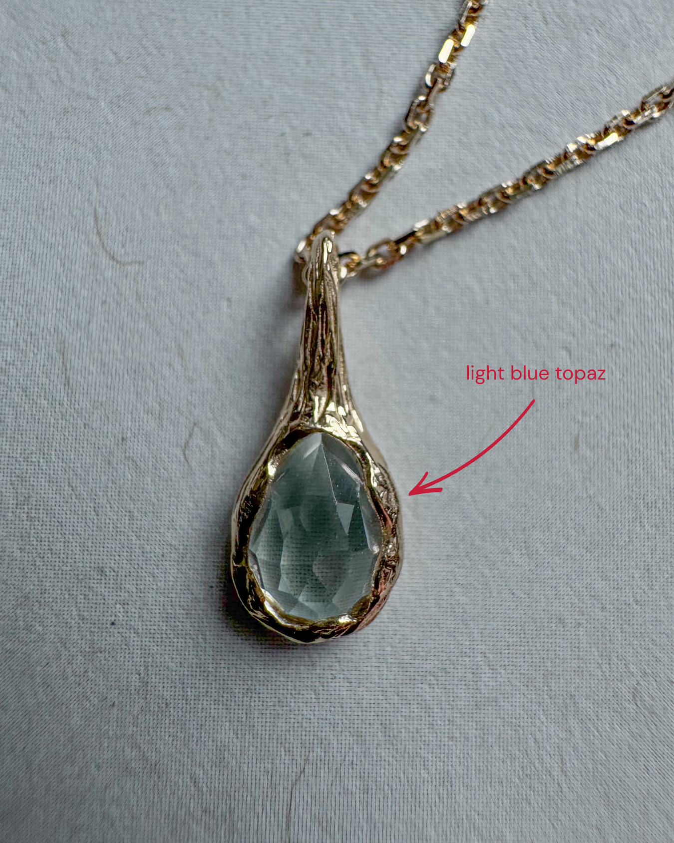 18ct gold-plated silver teardrop necklace with light blue topaz