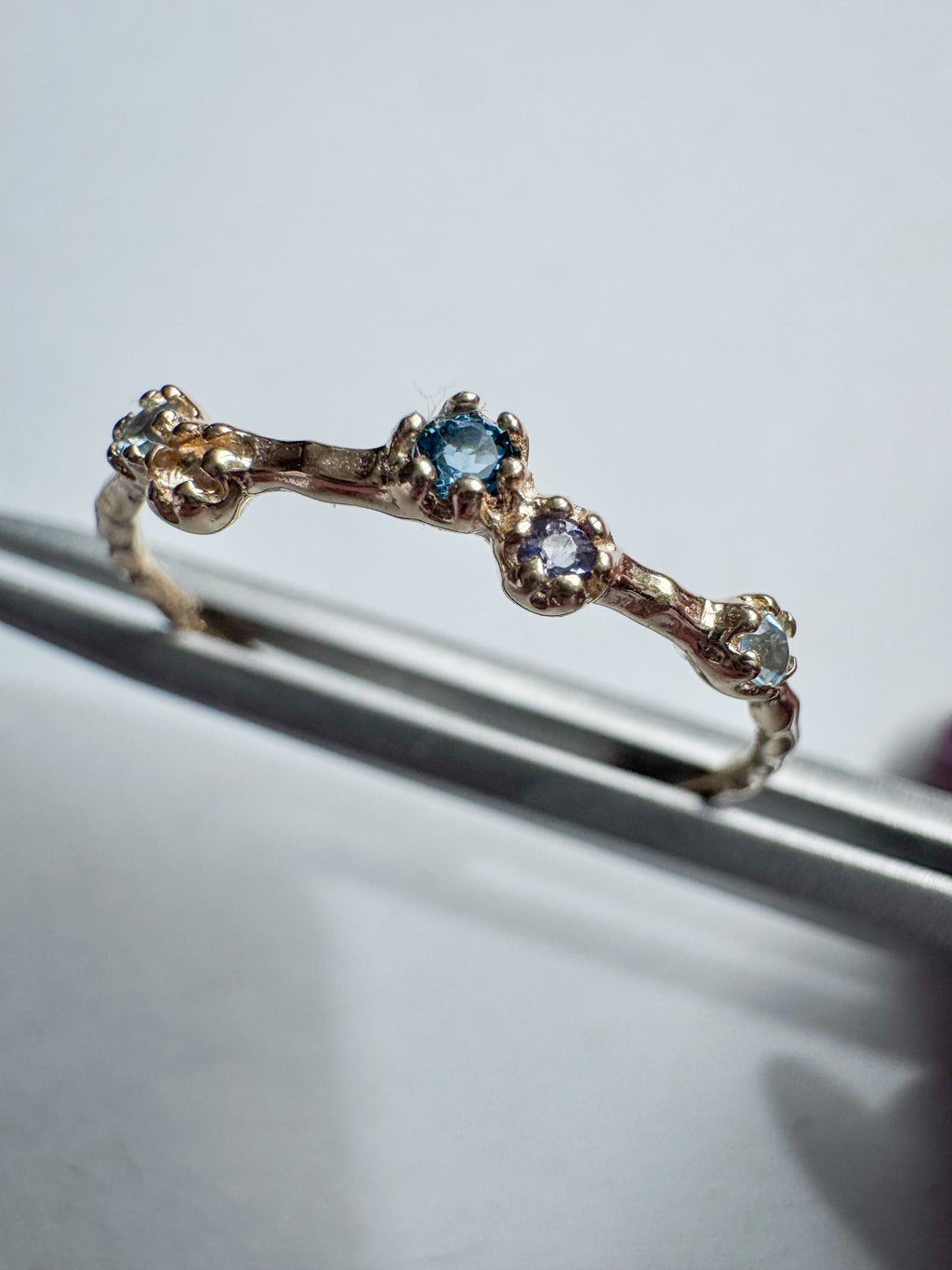Gold-plated sterling silver ring set with a brilliant-cut blue topaz and a round faceted iolite.