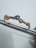 Gold-plated sterling silver ring set with a brilliant-cut blue topaz and a round faceted iolite.