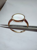 Gold-plated sterling silver ring with a round white mother of pearl stone on a slim band, bezel setting