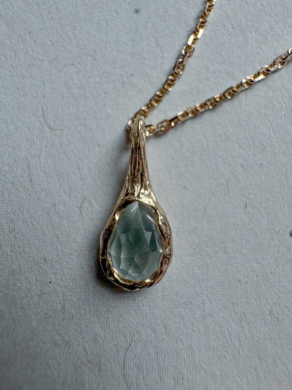 18ct gold-plated silver teardrop necklace with light blue topaz