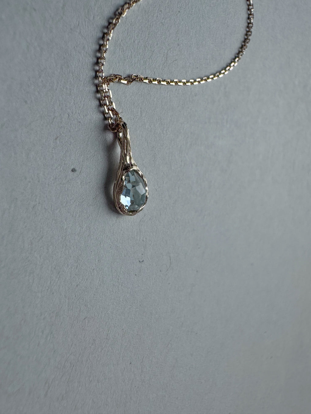 18ct gold-plated silver teardrop necklace with light blue topaz