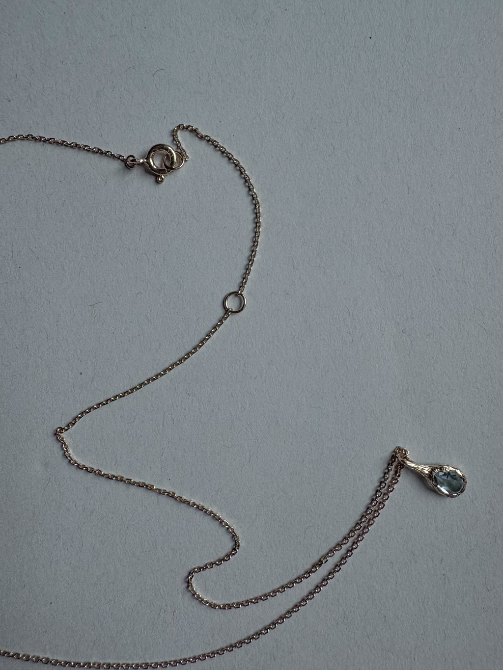 18ct gold-plated silver teardrop necklace with light blue topaz