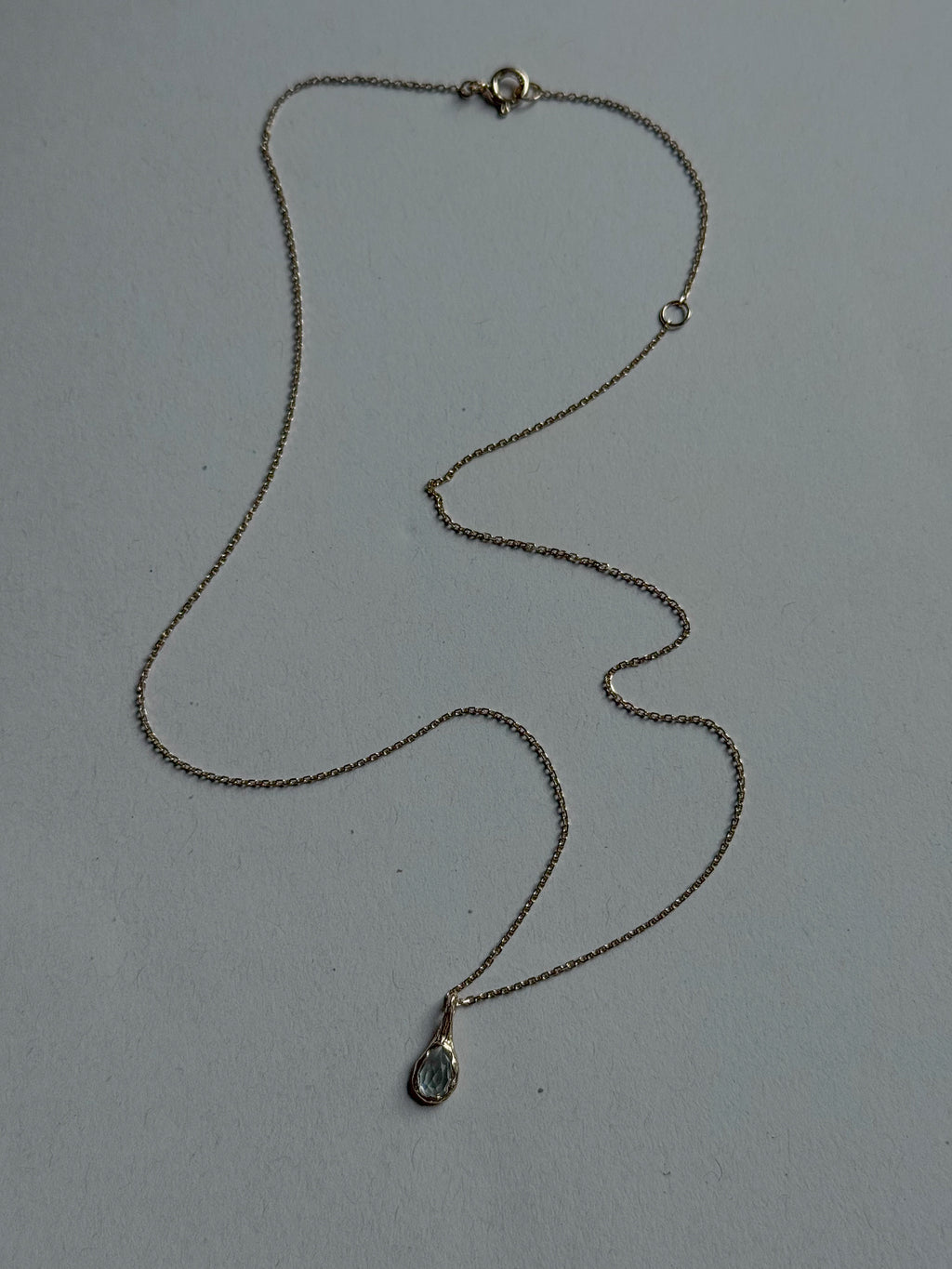 18ct gold-plated silver teardrop necklace with light blue topaz