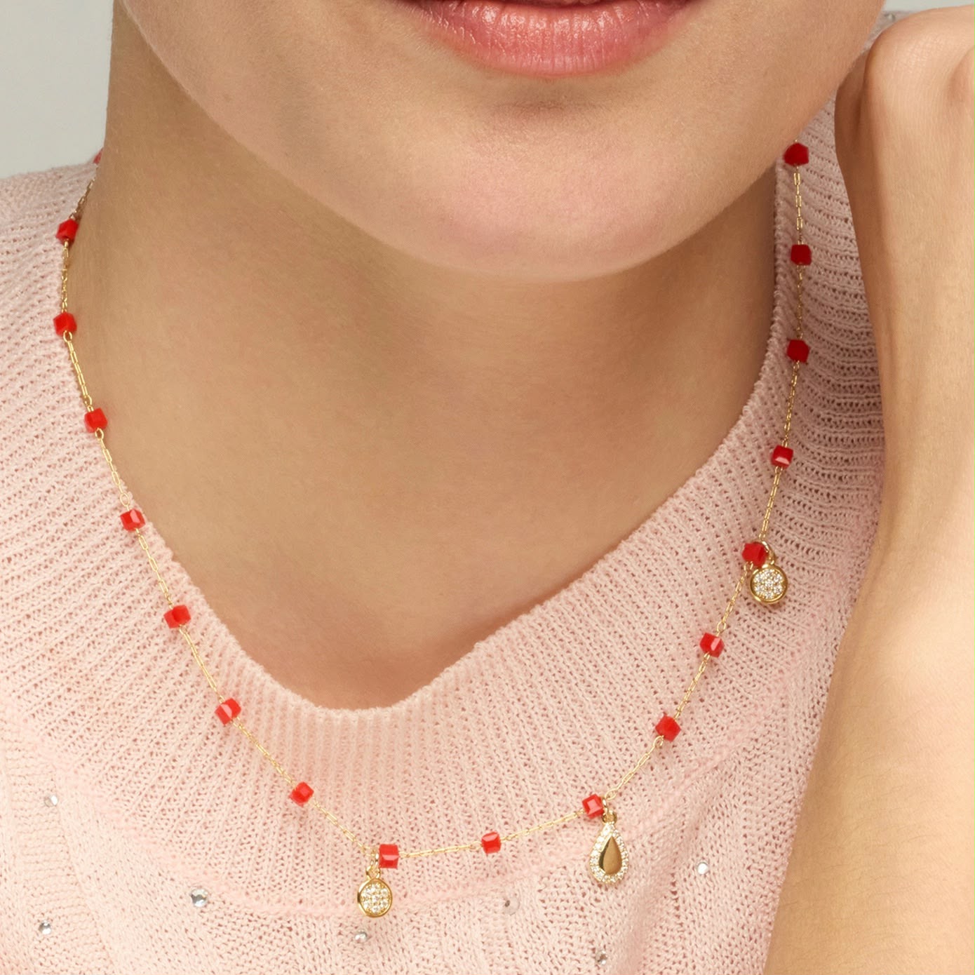 Gold-finish sterling silver necklace with red crystal beads and cubic zirconia pavé charms